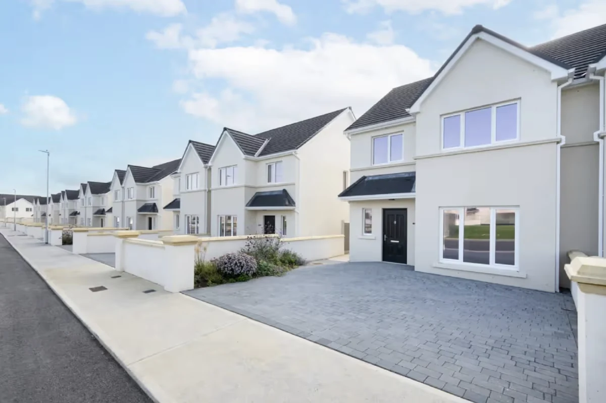 Residential housing in Cork with paved driveways, footpaths and landscaped front gardens
